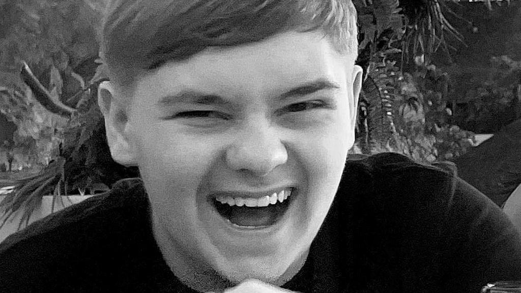 Harvey Willgoose, a smiling teenage boy with short hair, pictured in monochrome.