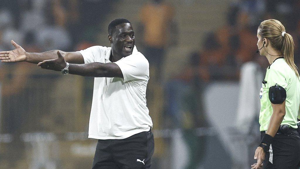 Ivory Coast interim manager Emerse Fae speaks to Moroccan official Bouchra Karboubi during their 2023 Africa Cup of Nations last 16 game against Senegal