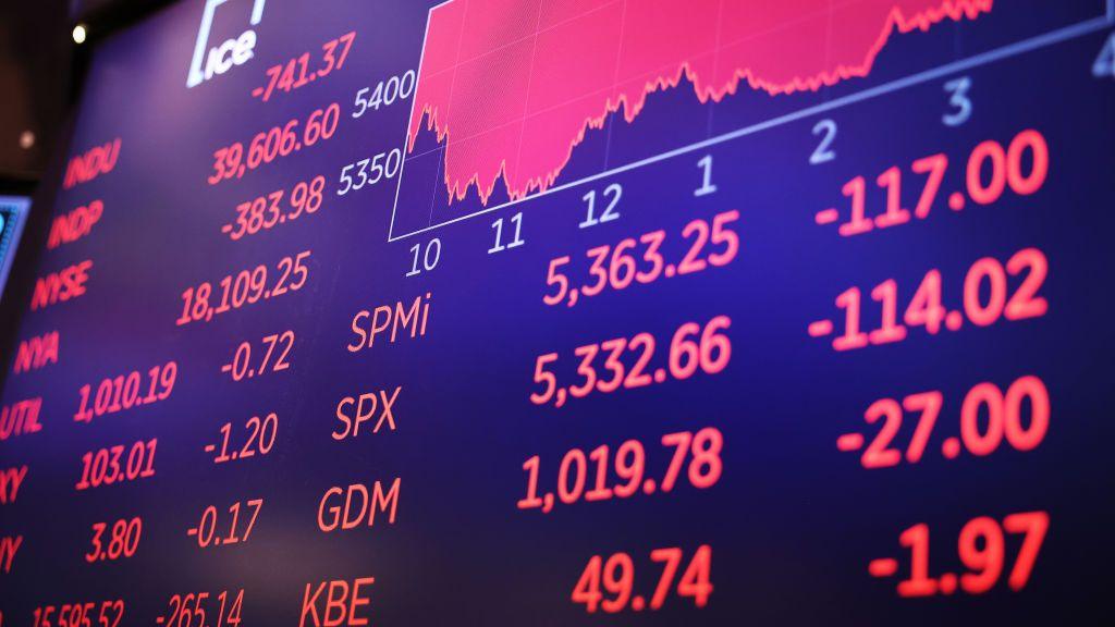 Stock market numbers are displayed on a screen at the New York Stock Exchange