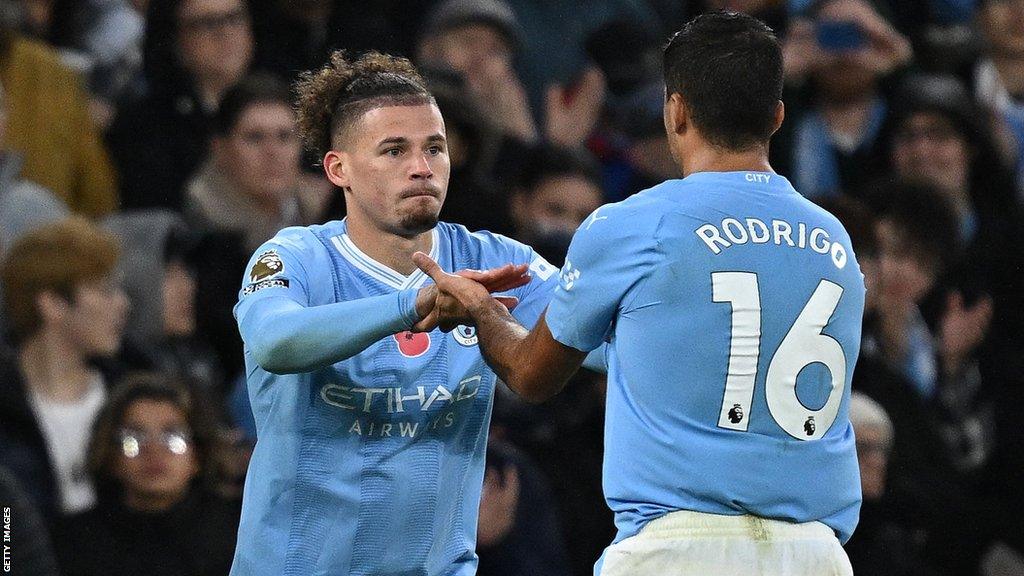 Manchester City midfielder Kalvin Phillips (left) replaces team-mate Rodri (right) during a Premier League game