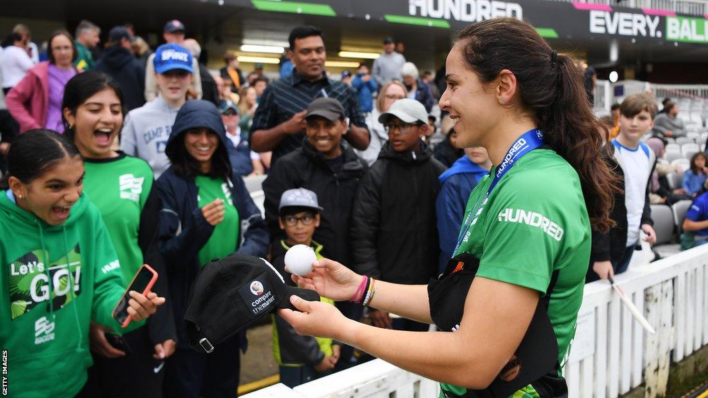 Maia Bouchier signs an autograph for a fan