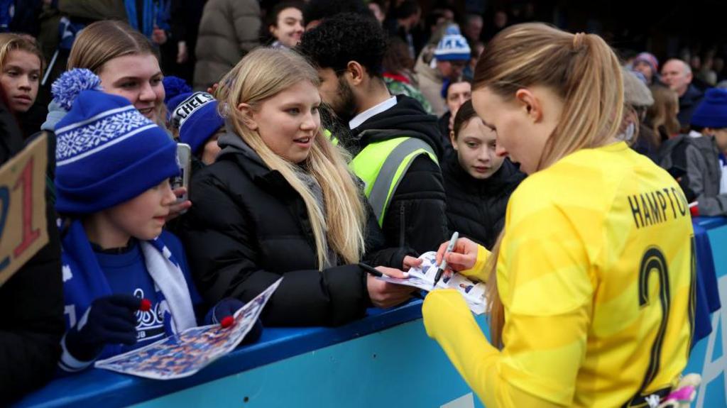 Hannah Hampton signing autographs after a game with fans at Kingsmeadow