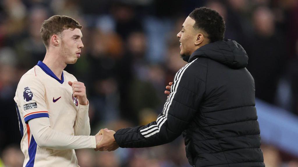 Morgan Rogers of Aston Villa interacts with Cole Palmer of Chelsea