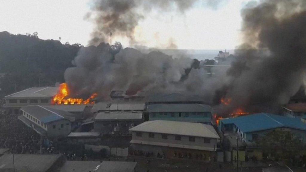 Fires break out as rioting crowds target government buildings in Solomon Islands.