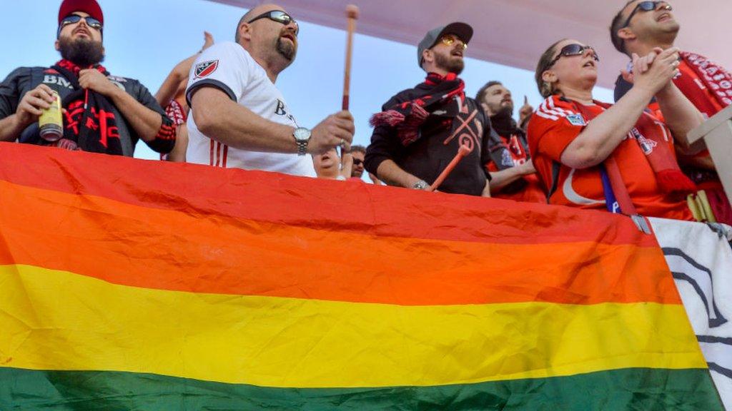 football fans and lgbtq flag