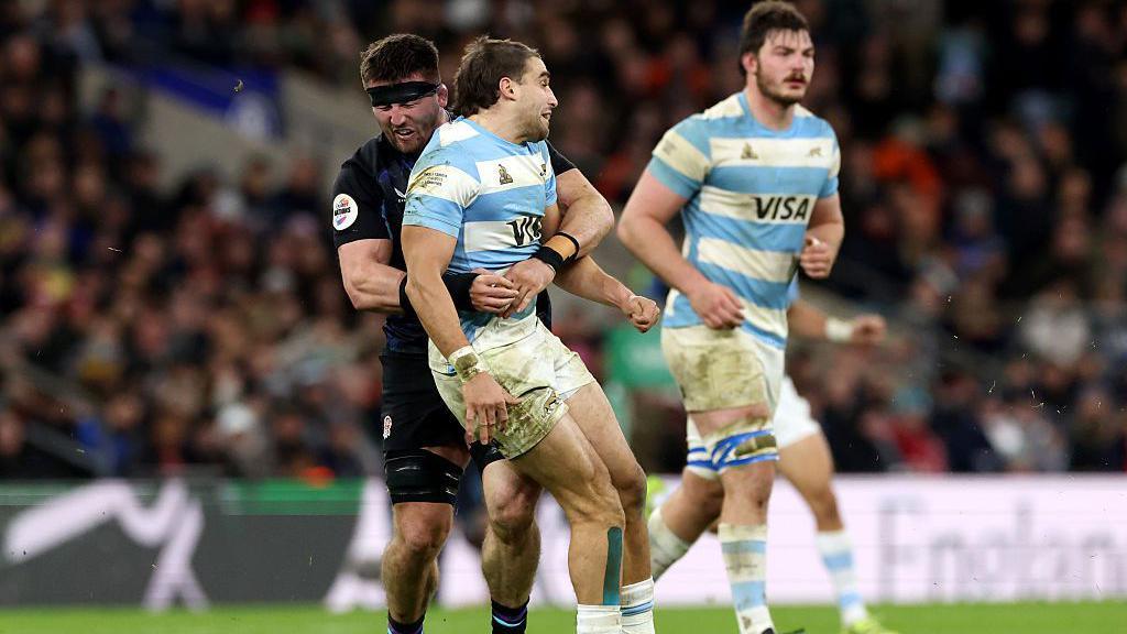 England's Tom Curry tackles Argentina's Juan Cruz Mallia in the autumn international at Allianz Stadium