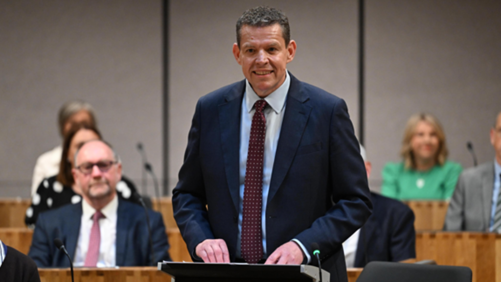 Rhun ap Iorwerth in a blue suit in the Senedd