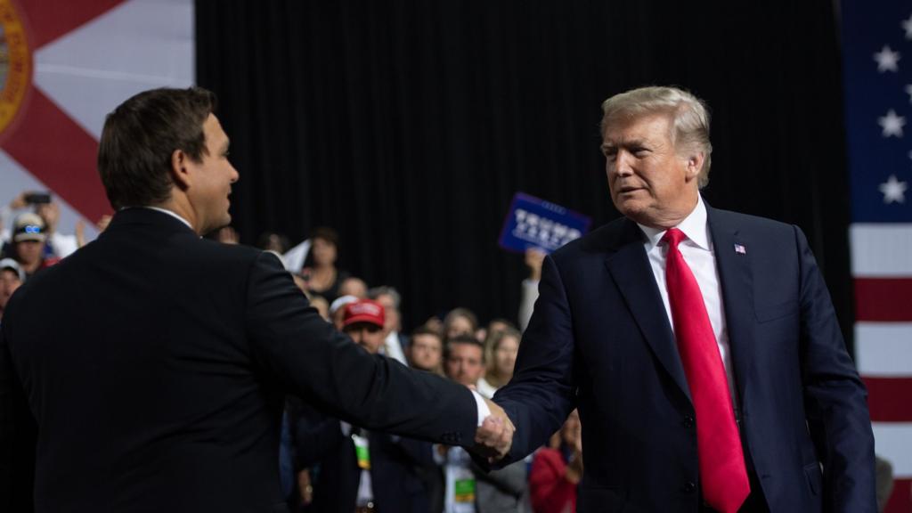 DeSantis and Trump shake hands