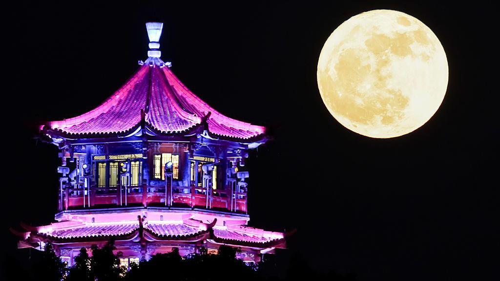 Strawberry Moon rising over a pavilion in Guang'an, Sichuan Province of China.