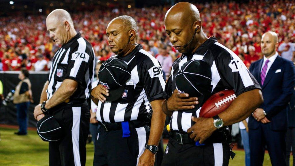 referees with hands over hearts