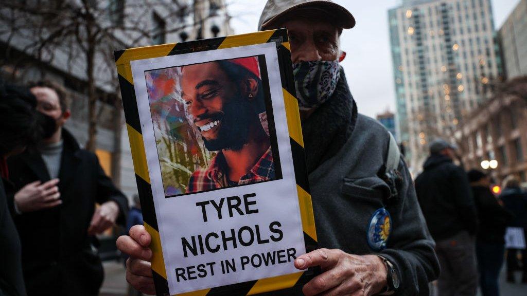 Photo of protestor in Oakland holding sign that says 'Tyre Nichols Rest in Power'