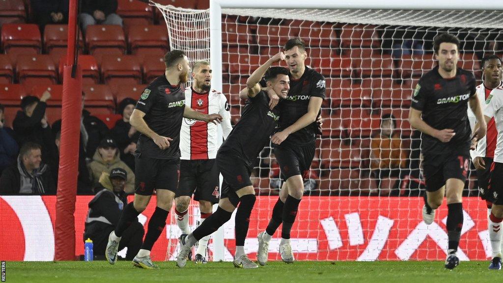 Lincoln City celebrate the own goal that put them ahead early on at Southampton