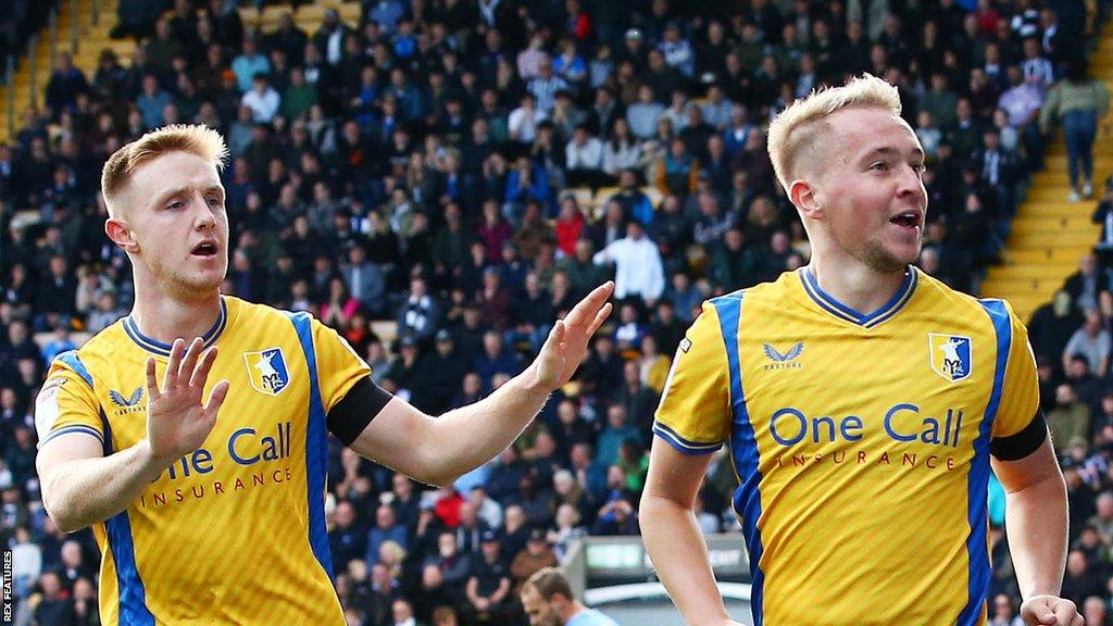 Louis Reed (right) celebrates scoring for Mansfield against Notts County