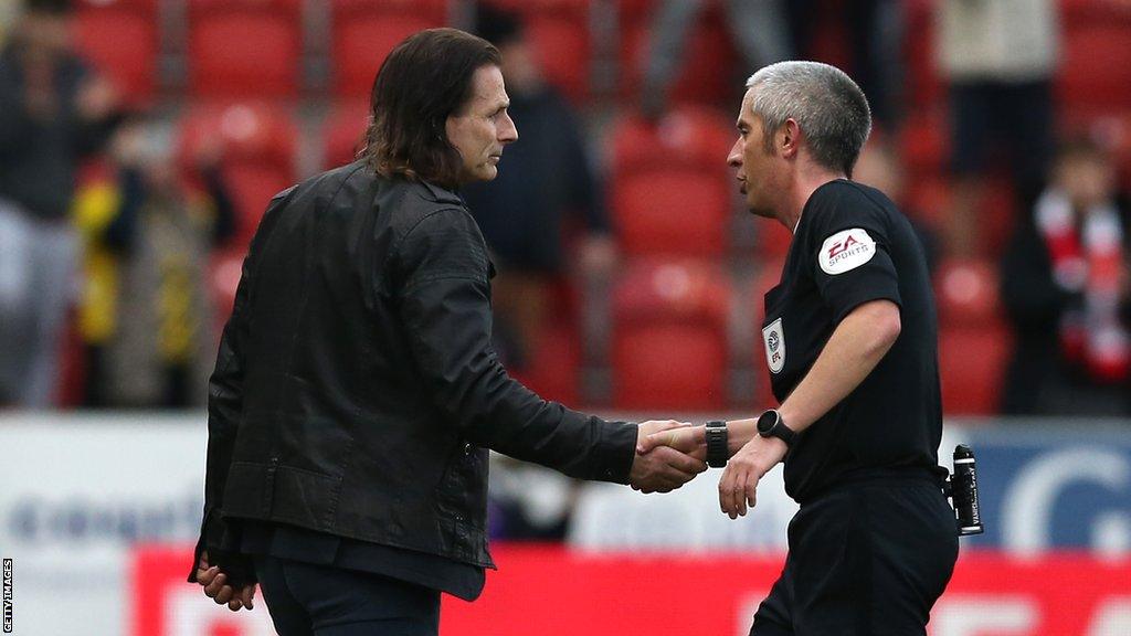 Gareth Ainsworth shakes hands with referee Darren Bond