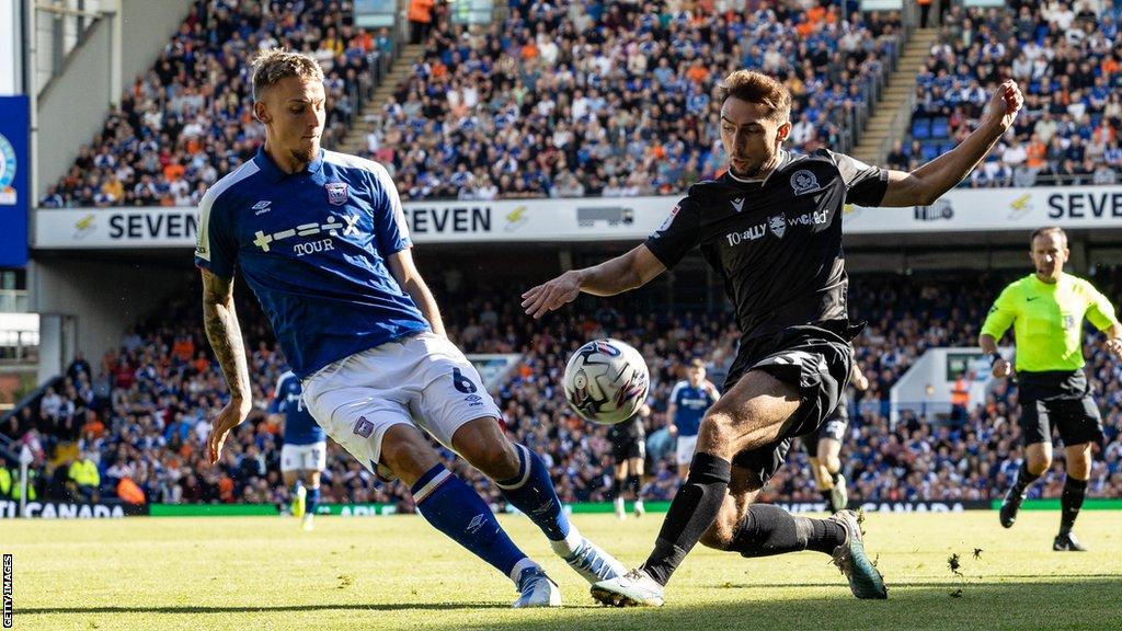 Luke Woolfenden of Ipswich tackles Blackburn's Harry Pickering during a Championship match