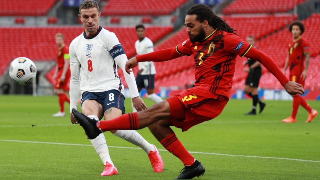 Jason Denayer clears under pressure from Jordan Henderson