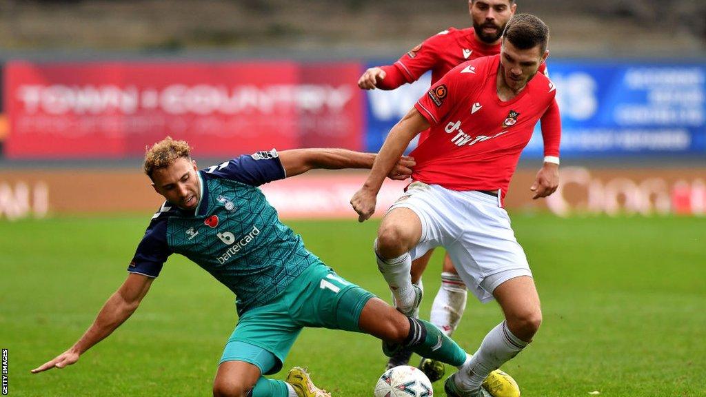 Wrexham's Jordan Tunnicliffe in action against Oldham Athletic