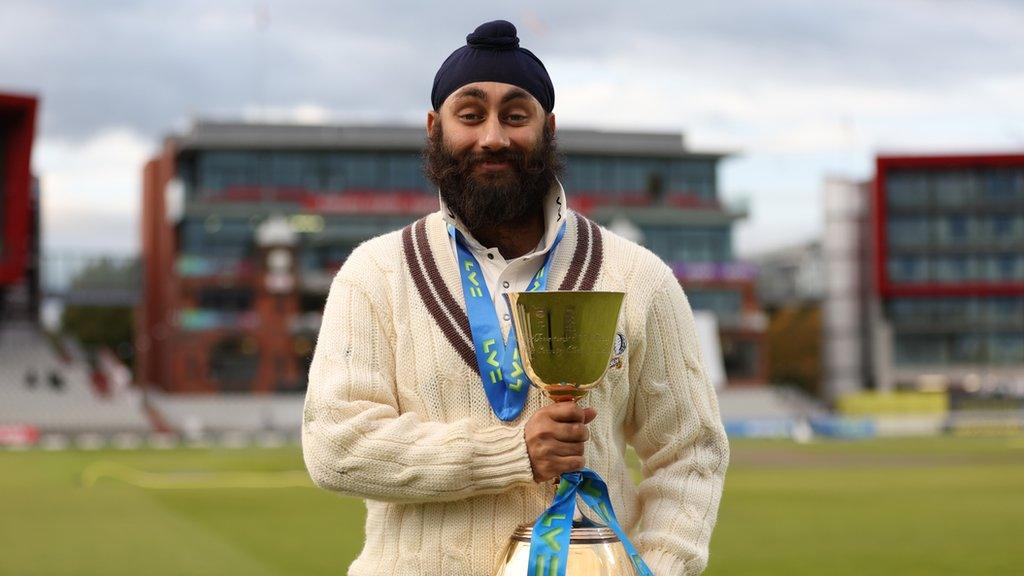 Amar Virdi of Surrey holding a trophy