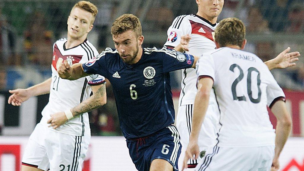 Midfielder James Morrison weaves through the German defence