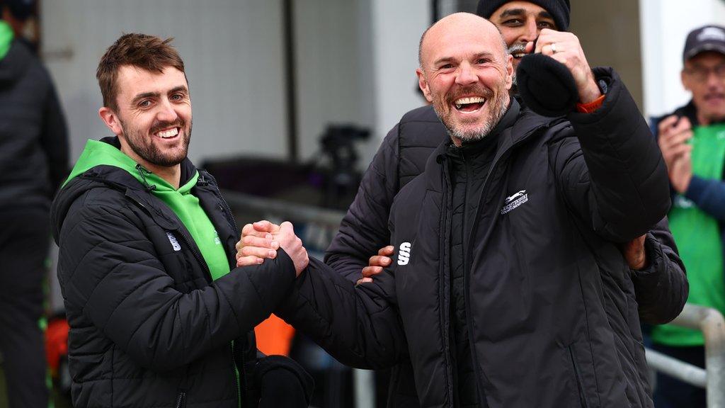 Lewis Hill (left) clasps hands with Leicestershire coach Paul Nixon