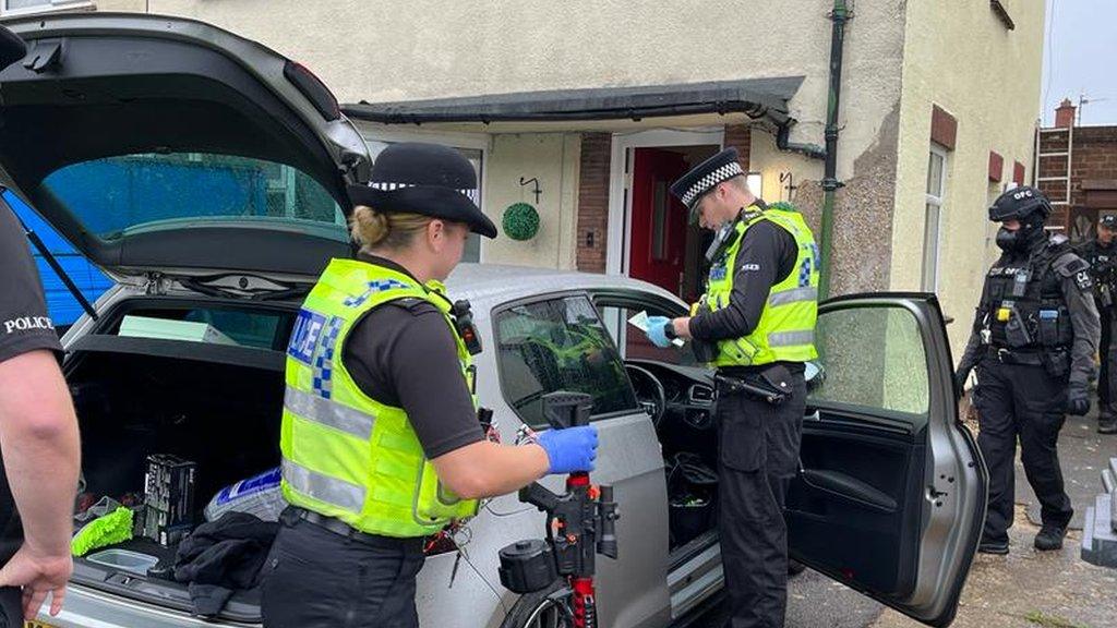 Police officers searching car