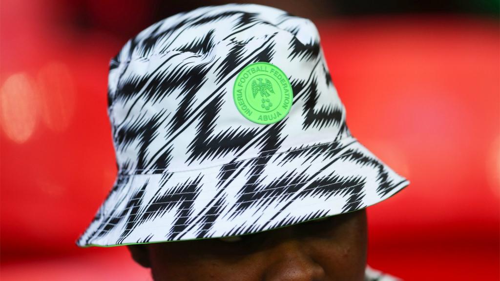 A Nigeria football fan wears the hat from the World Cup kit