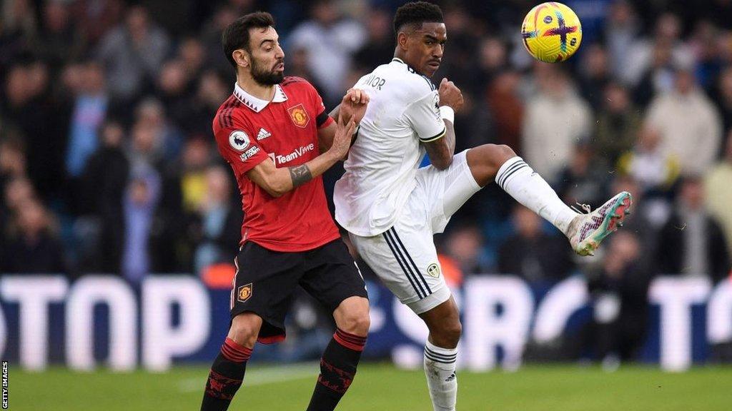 Manchester United's Portuguese midfielder Bruno Fernandes vies with Leeds United's defender Junior Firpo during Sunday's game at Elland Road