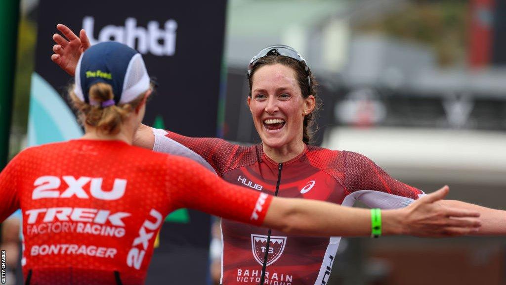 Kat Matthews and Taylor Knibb embrace at the finish line