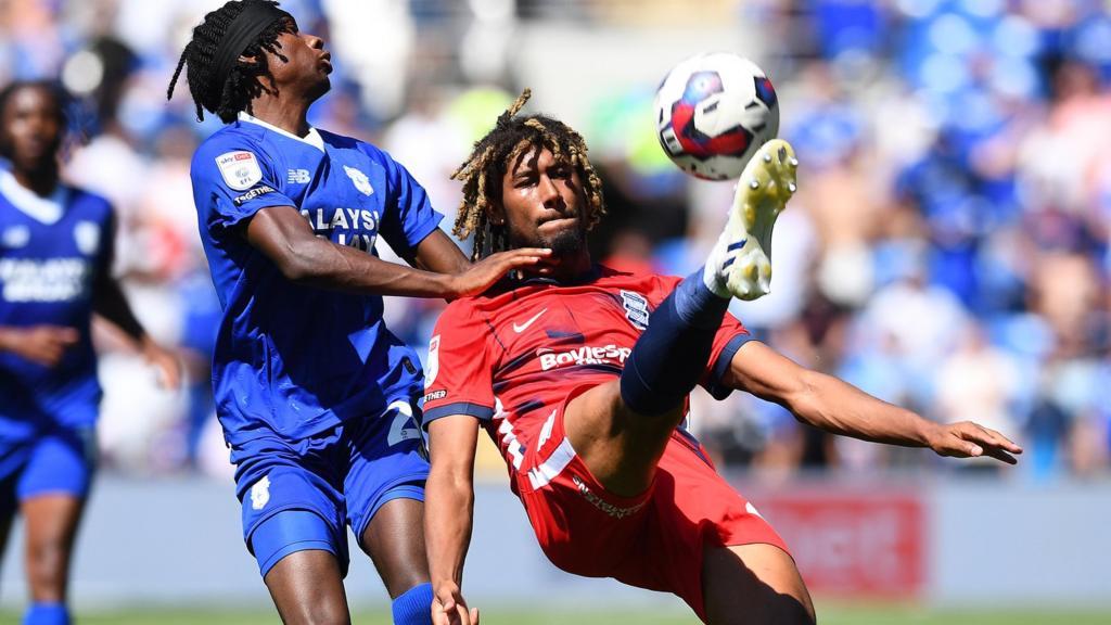 Dion Sanderson of Birmingham City is tackled by Jaden Philogene