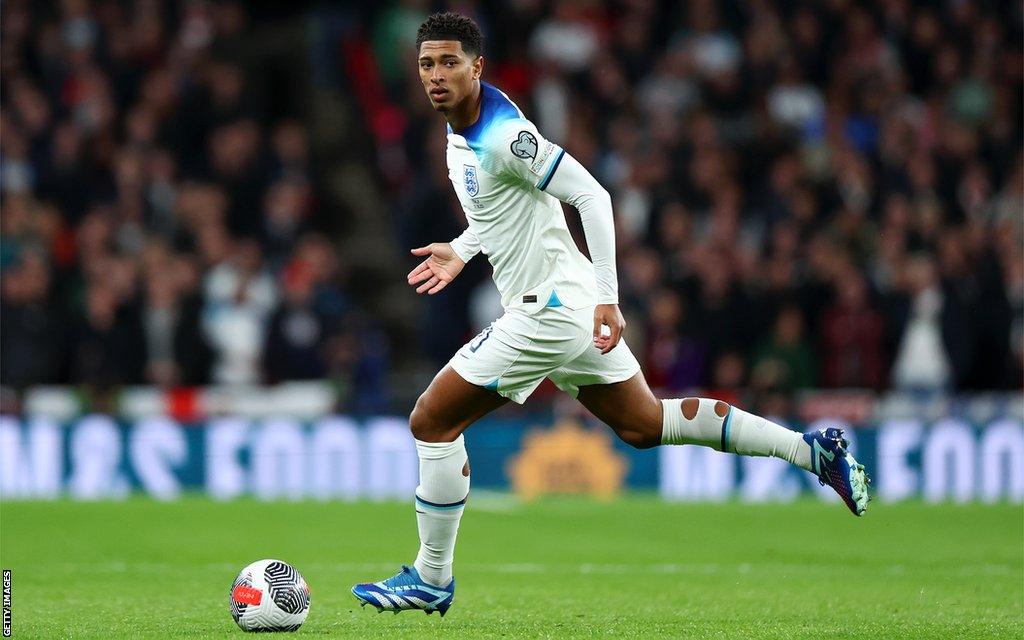 Jude Bellingham runs with the ball while playing for England