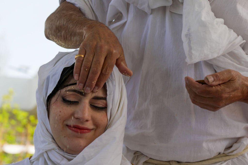 Ranyia Raid takes part in ritual purification during her wedding ceremony