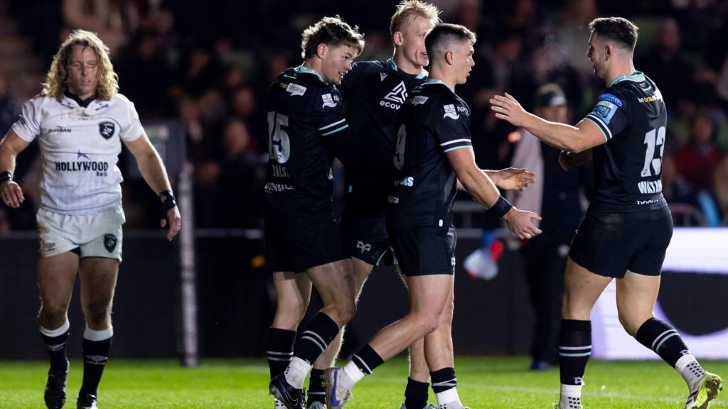 Jack Walsh (2nd L) celebrates his try