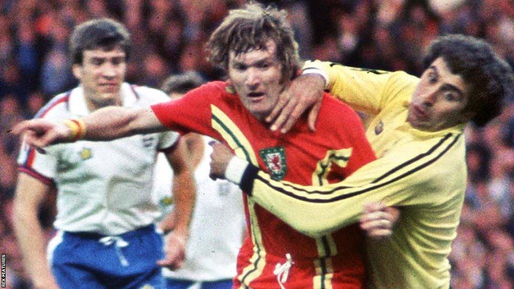 Leighton James (L) is fouled by Peter Shilton (R) which resulted in a penalty that James took and scored their winning goal from England v Wales at Wembley