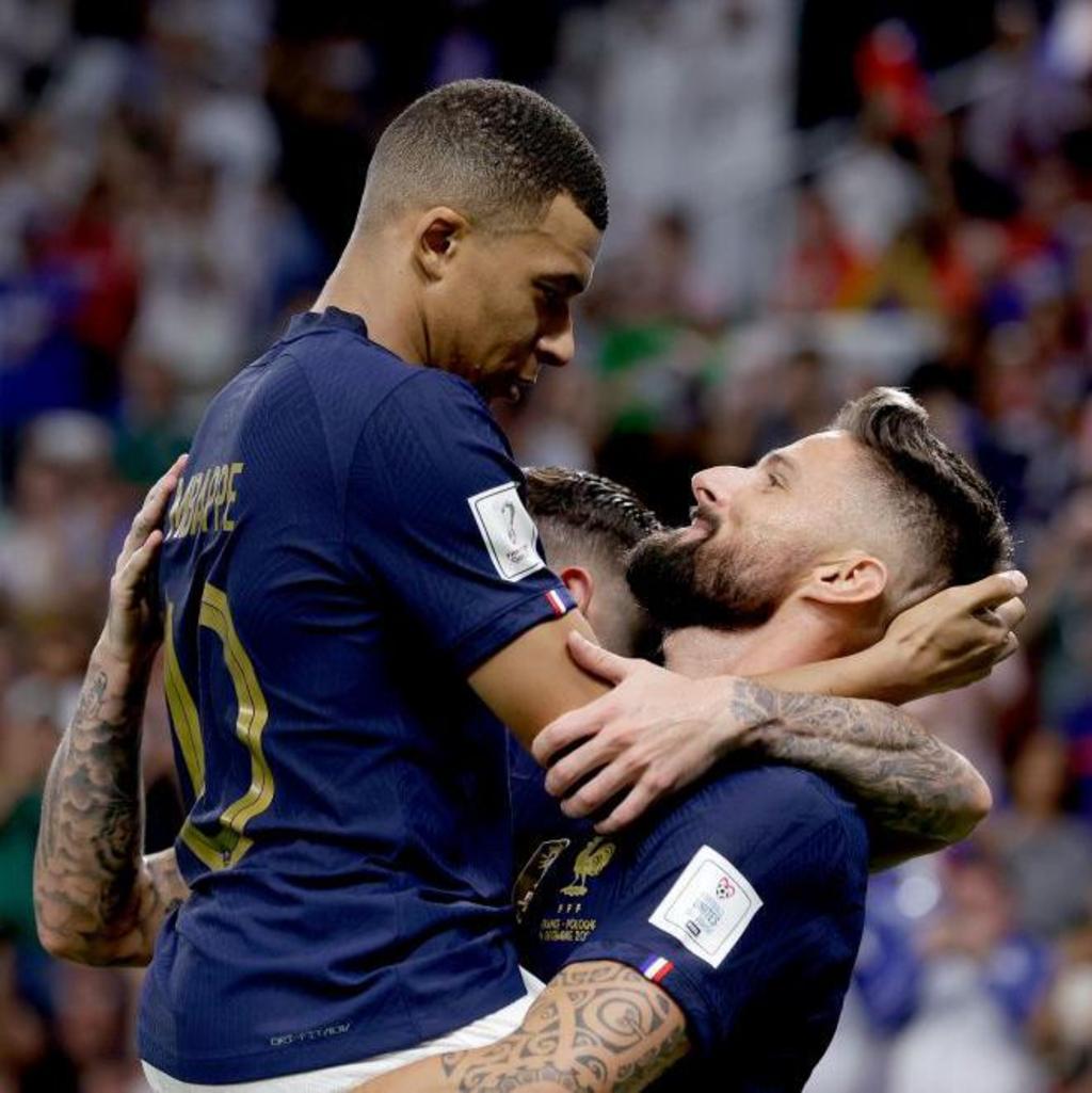 Kylian Mbappe (left) celebrates with Olivier Giroud after Giroud's record-breaking goal against Poland in 2022