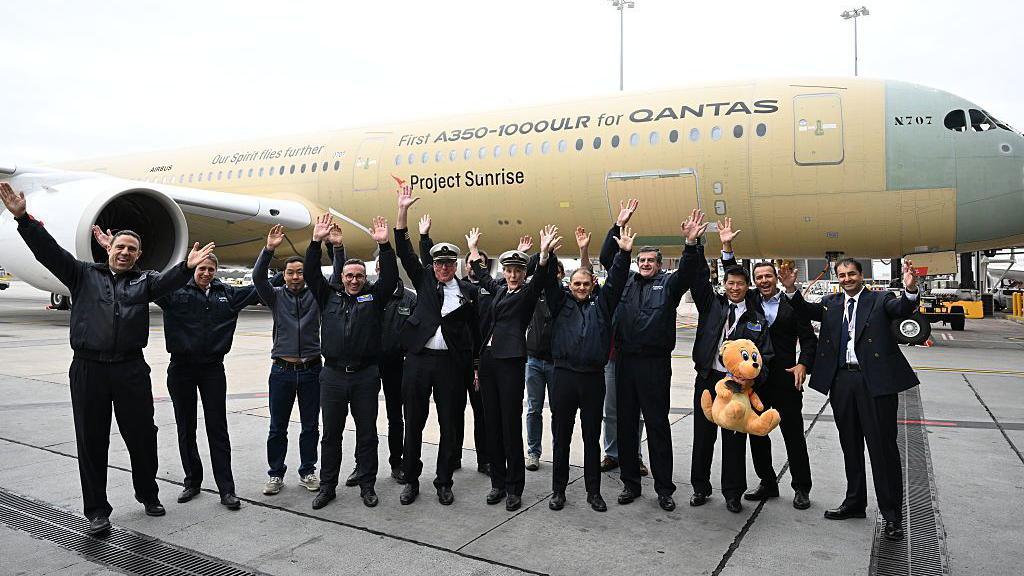 Qantas flight crew pose for a photo on the tarmac with the crew of an Airbus A350-100ULR after landing at Melbourne Airport on July 24, 2026.