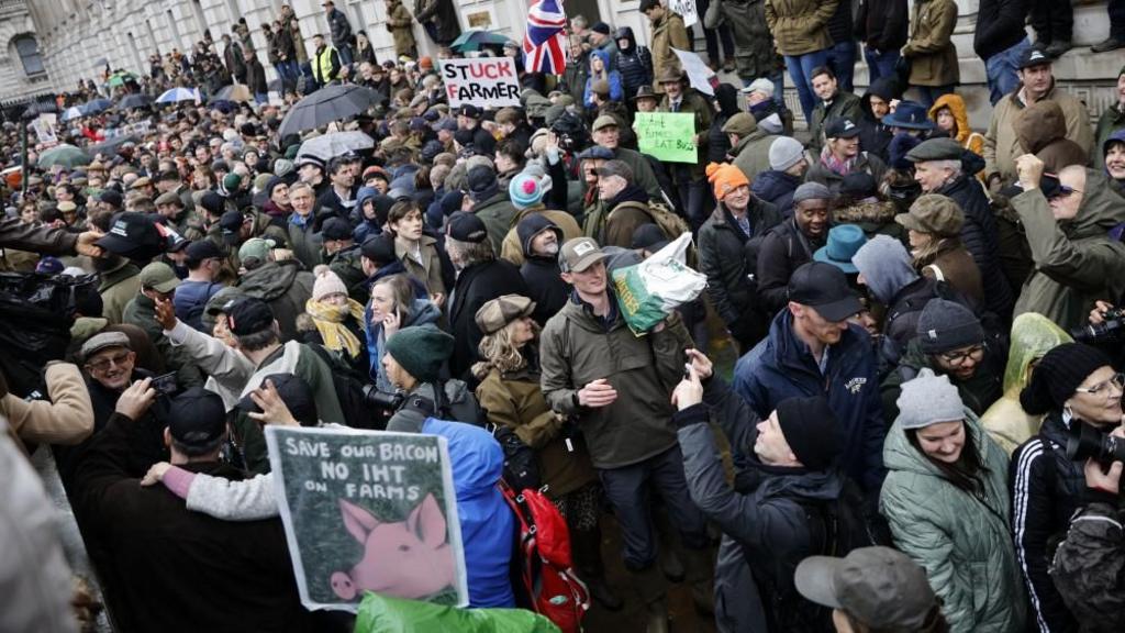 Farmers hold placards during a protest in Westminster 