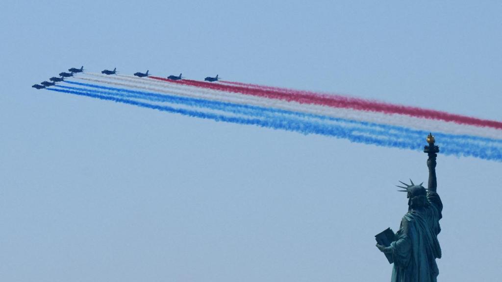 Military aircraft perform a flyover near the Statue of Liberty during the Sail 250 parade of ships in New York Harbor as the United States celebrates its 250th anniversary on Independence Da