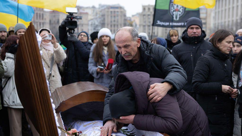 Ukrainians cry at a funeral in Kyiv, January 2024