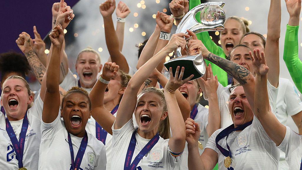 the england womens football team lifting the euros trophy and celebrating in 2022