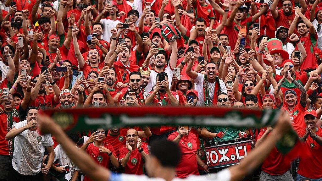 Morocco fans celebrate after watching their team beat Canada