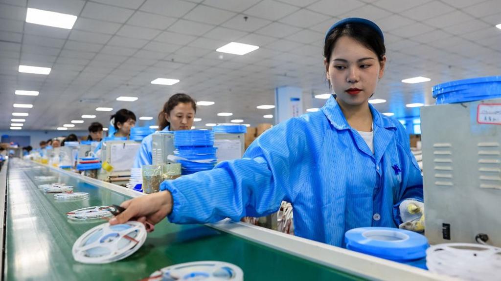 Employees work in a factory that produces LED lights for export in Jiujiang, China