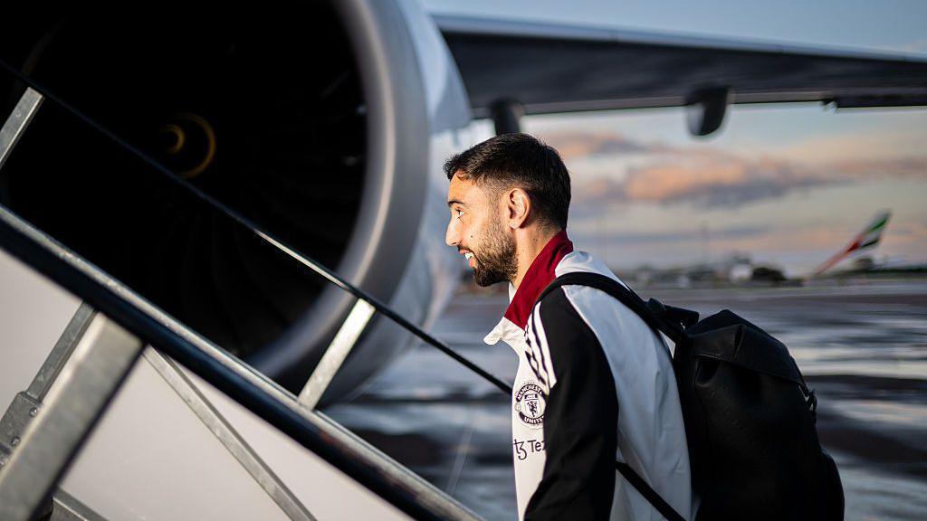 Bruno Fernandes boards a plane at Manchester Airport