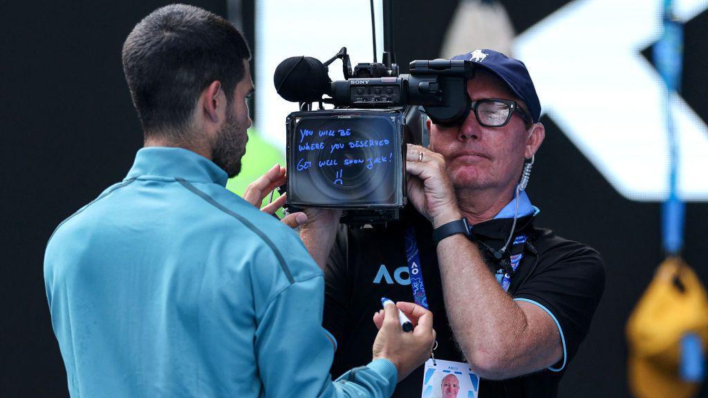 Carlos Alcaraz writes 'you will be where you deserved. Get well soon Jack!' on a TV camera