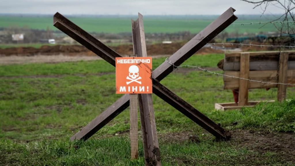 A sign warning of a minefield stands near a defence position, where Ukraine's National Guard prepares to defend Odessa