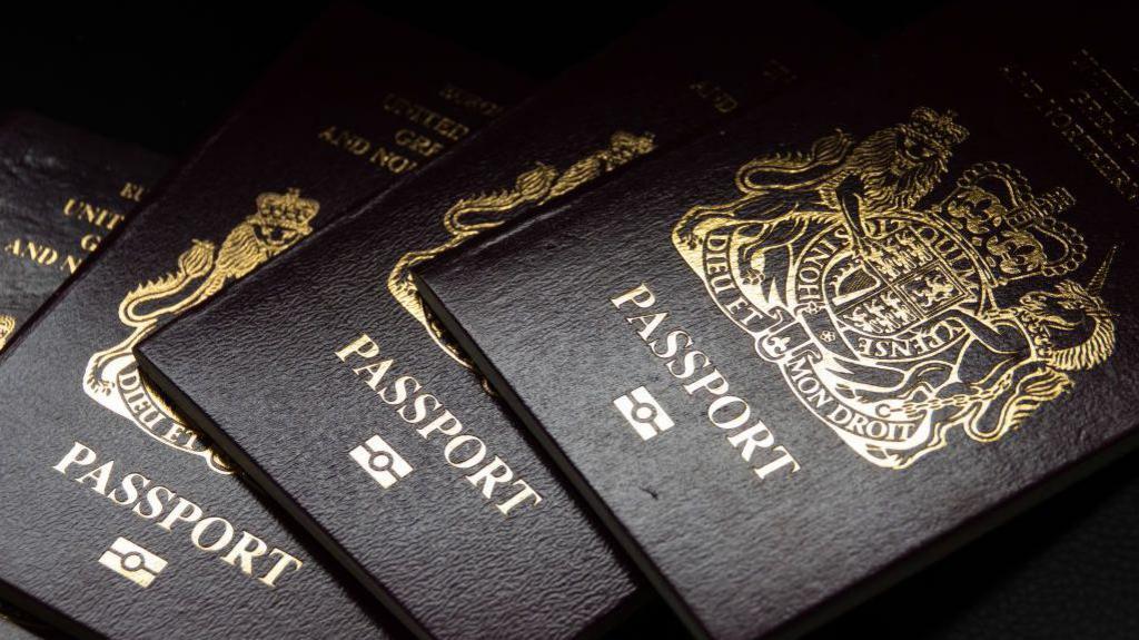 Several UK passports next to each other