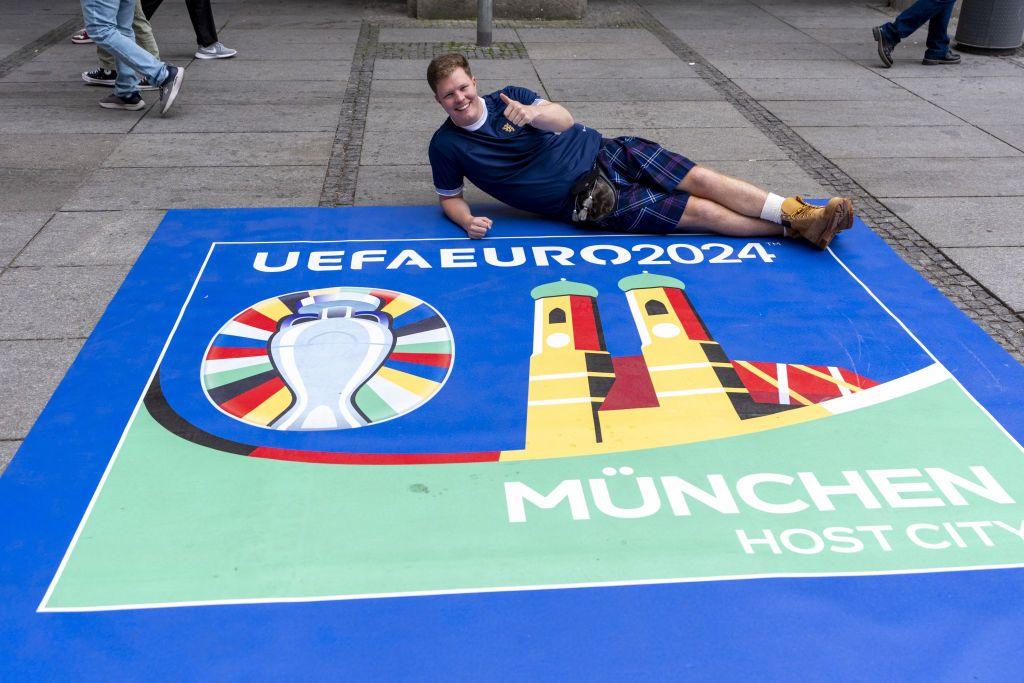 Scotland fan posing with Euro 2024 sign. 