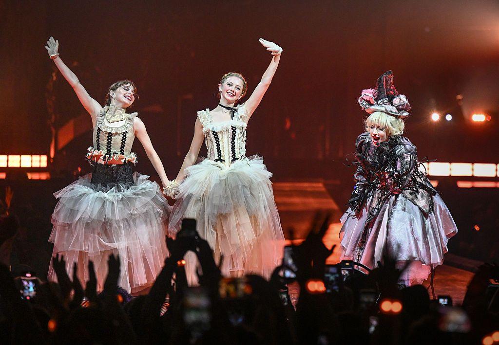 Emma Myers and Evie Templeton on stage with Lady Gaga