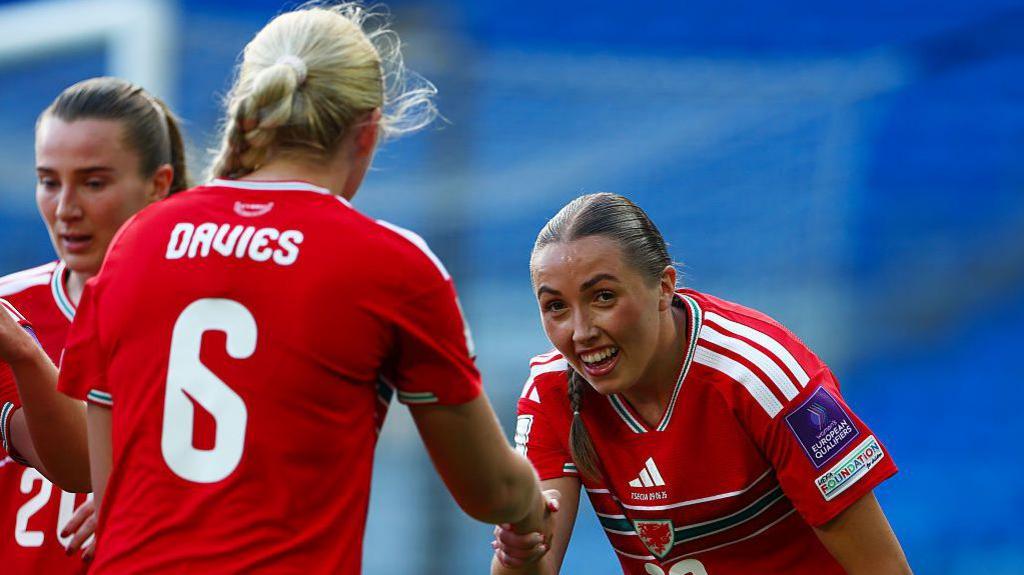 Mayzee Davies celebrates with Mared Griffiths 