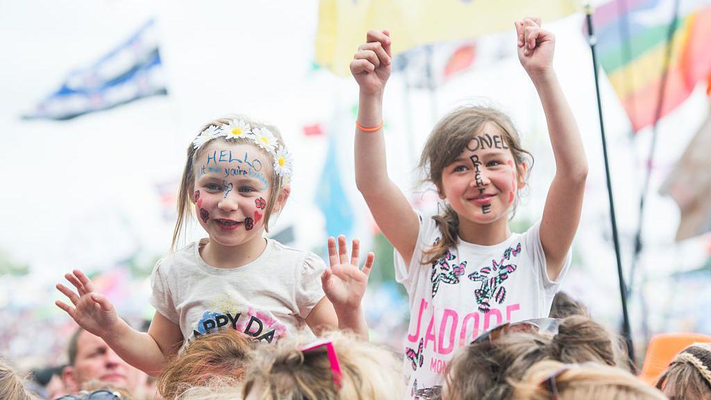 kids in face paint at glasontbury