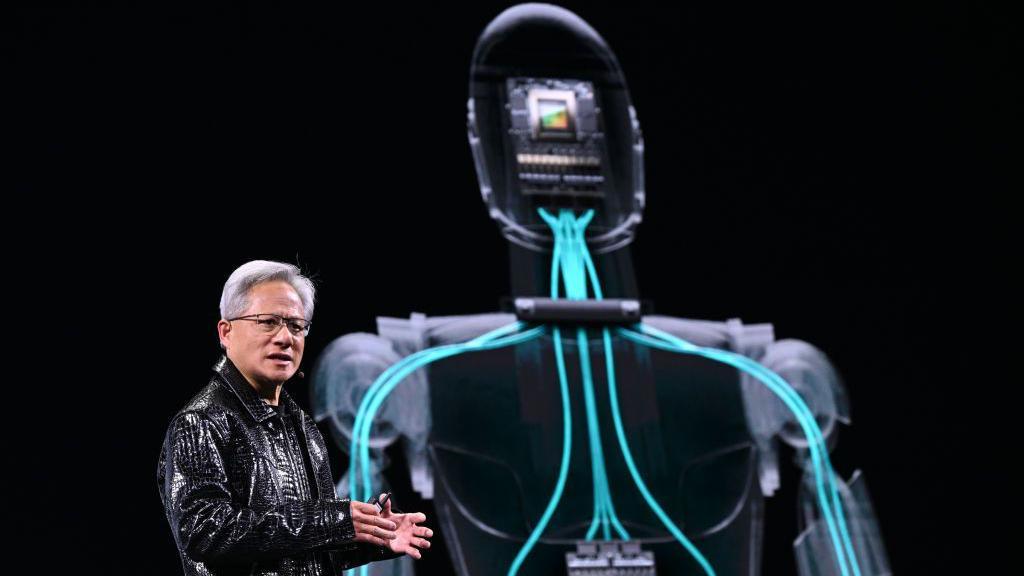 Jensen Huang's making his keynote address at CES, an annual technology show in Las Vegas. He is standing in front of a projection of a robot.